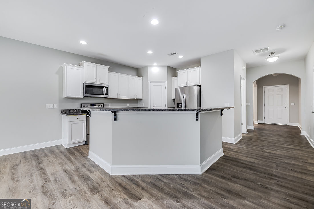 4 Bridlington Way Savannah, GA 31407 - Photo 12 of 38 a view of a kitchen with wooden floor and electronic appliances