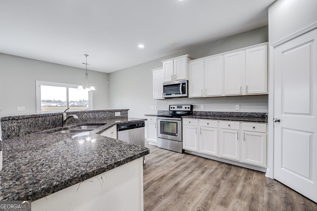 4 Bridlington Way Savannah, GA 31407 - Photo 13 of 38 a kitchen with stainless steel appliances granite countertop a sink a stove and microwave