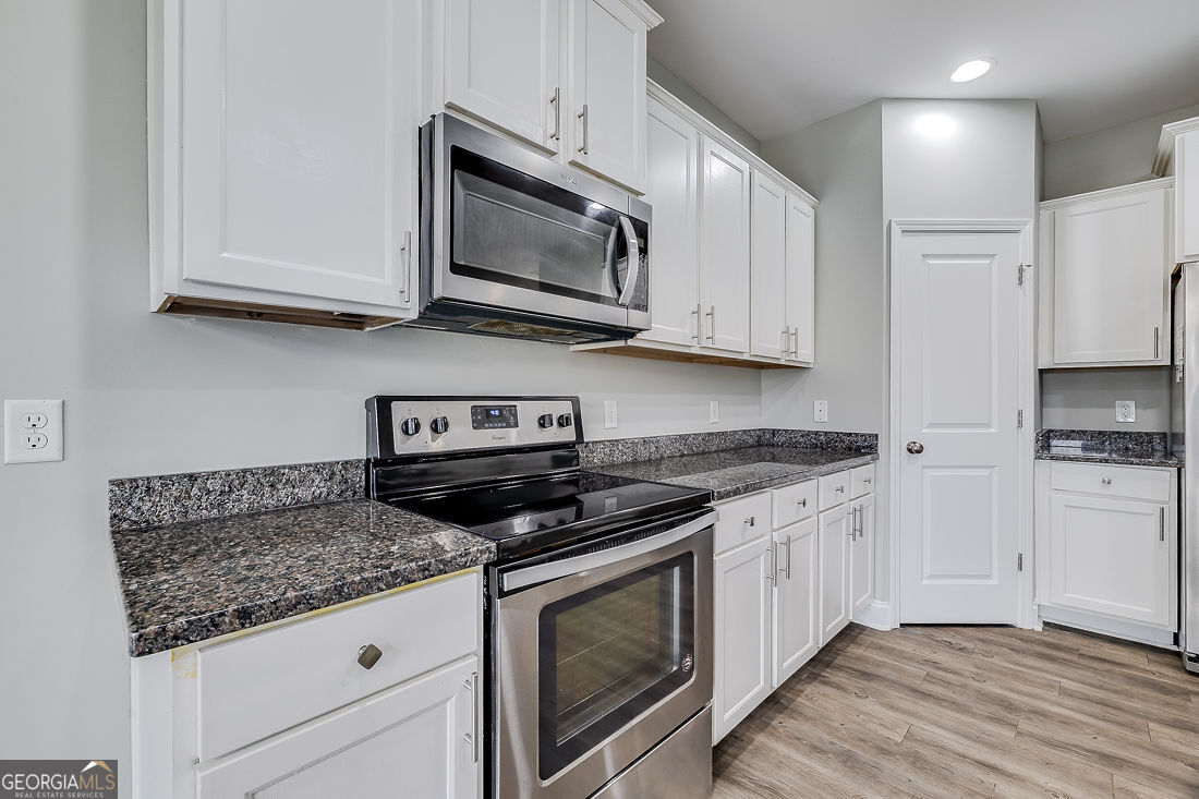4 Bridlington Way Savannah, GA 31407 - Photo 16 of 38 a kitchen with granite countertop white cabinets stainless steel appliances and a sink