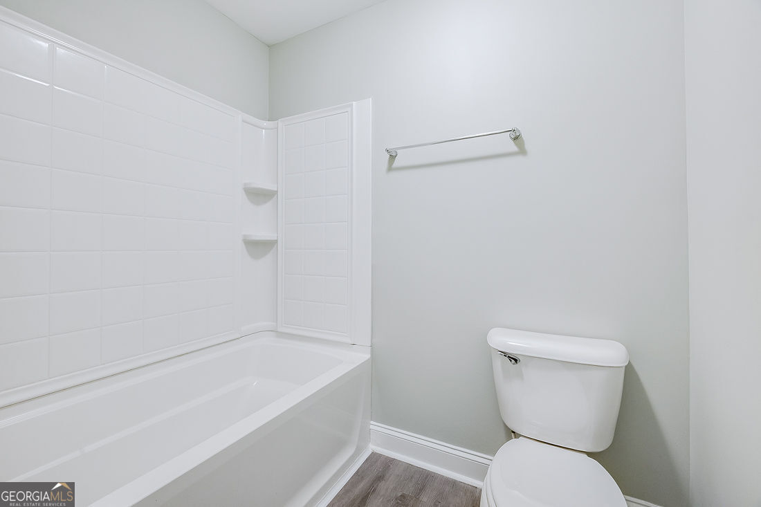 4 Bridlington Way Savannah, GA 31407 - Photo 32 of 38 a white toilet sitting next to a bath tub