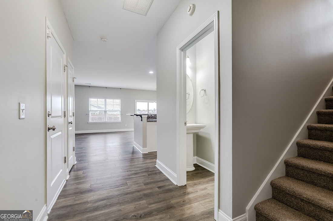 4 Bridlington Way Savannah, GA 31407 - Photo 6 of 38 a view of a hallway with wooden floor and a living room