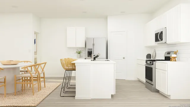 a kitchen with a table chairs and a refrigerator