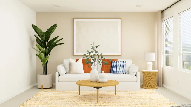 a living room with furniture and a potted plant