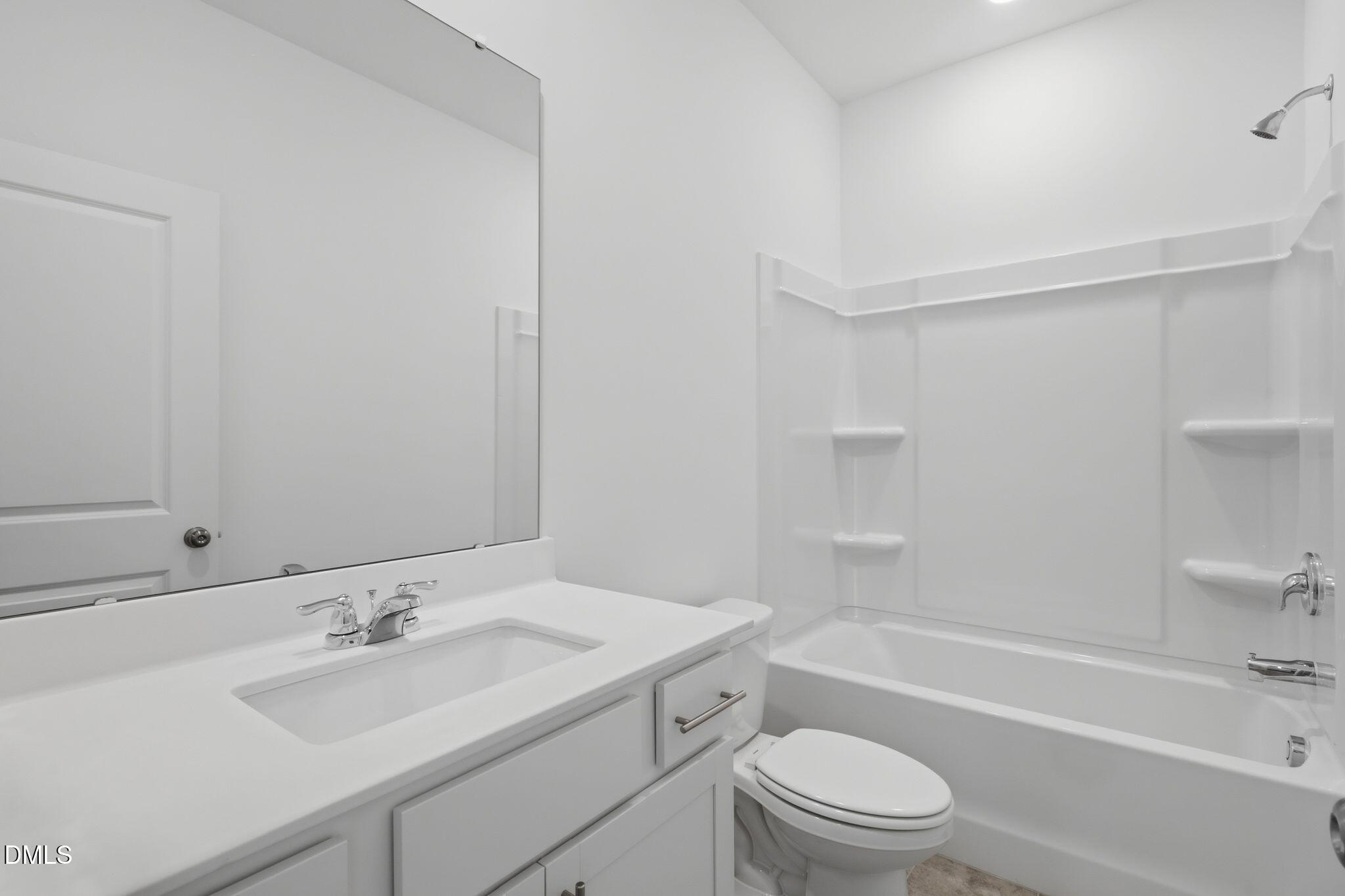 155 Digging Time Avenue Princeton, NC 27569 - Photo 21 of 29 a bathroom with a sink a toilet and shower