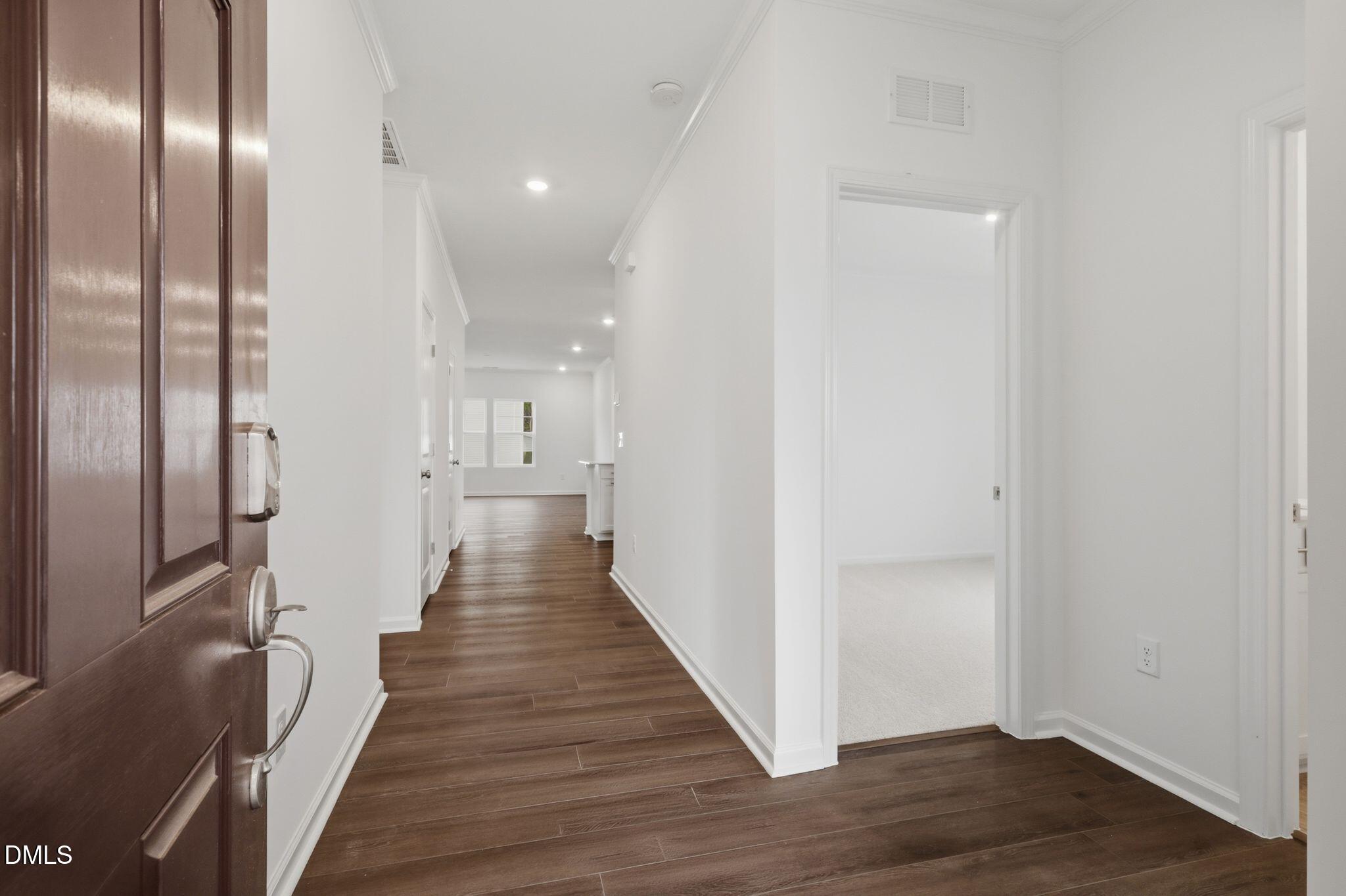 155 Digging Time Avenue Princeton, NC 27569 - Photo 4 of 29 a view of a hallway with wooden floor