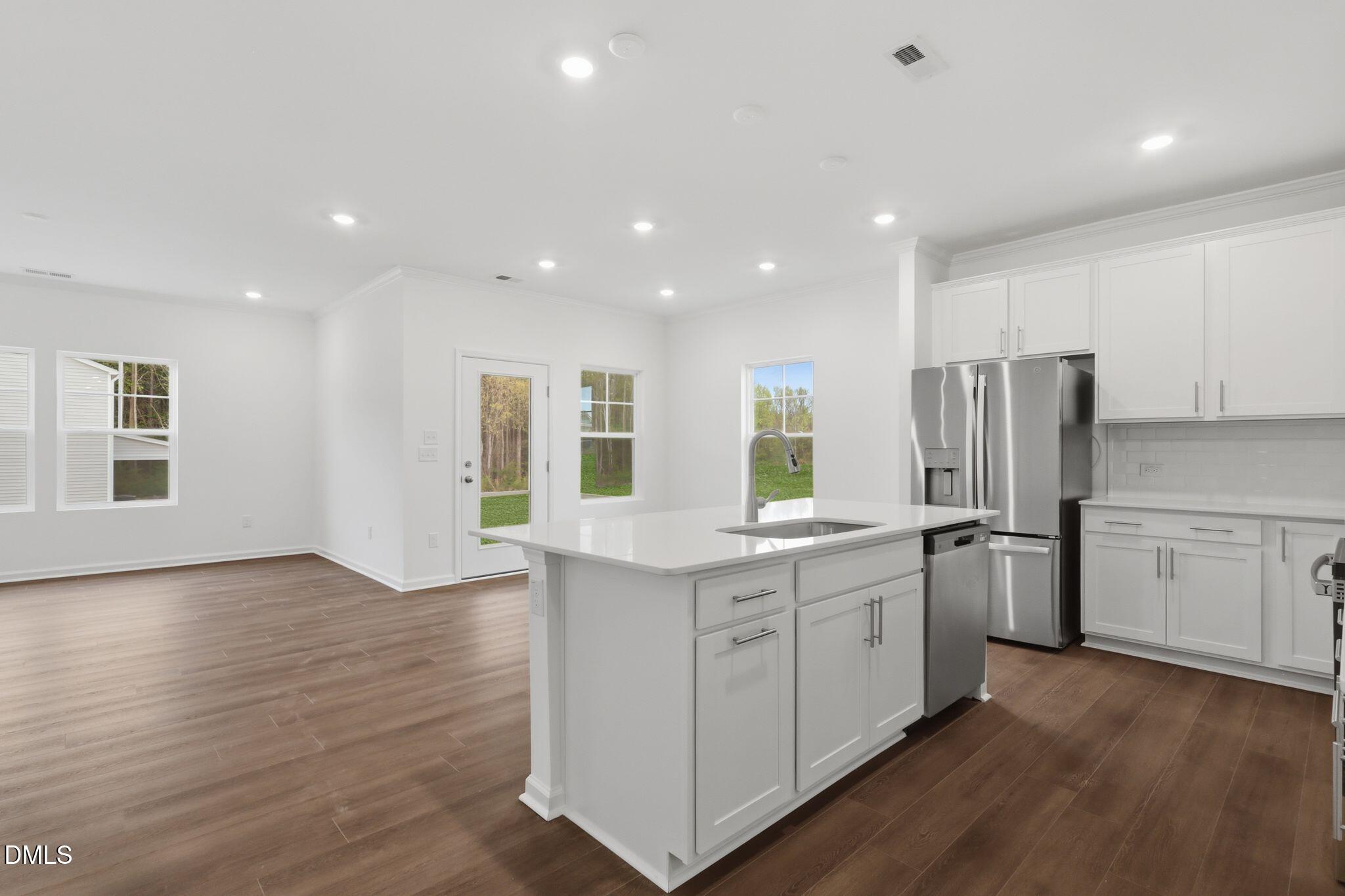 155 Digging Time Avenue Princeton, NC 27569 - Photo 9 of 29 a kitchen with stainless steel appliances granite countertop a stove and a refrigerator
