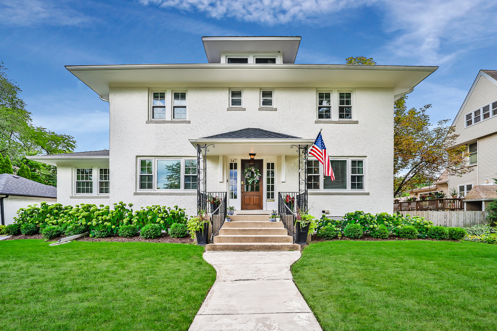 147 Herrick Road Riverside, IL 60546 - Photo 1 of 55 a front view of a house with garden and plants