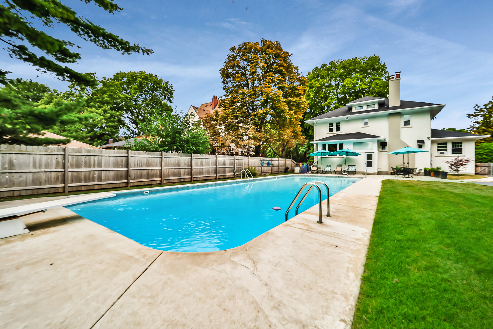 147 Herrick Road Riverside, IL 60546 - Photo 52 of 55 a view of a swimming pool with a bench and trees