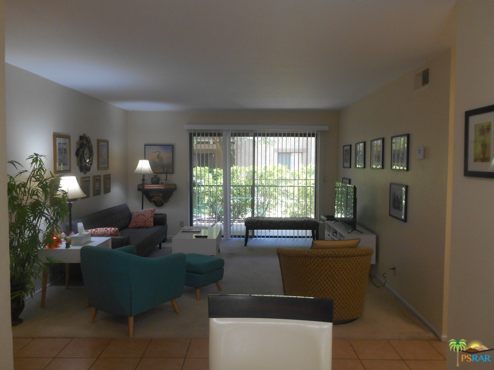 1050 Ramon Road, Unit 20 Palm Springs, CA 92264 - Photo 11 of 35 a living room with furniture and a large window