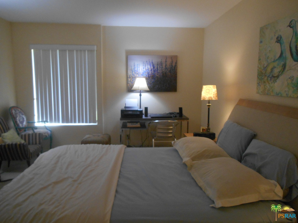 1050 Ramon Road, Unit 20 Palm Springs, CA 92264 - Photo 15 of 35 a bed room with a bed and a couch