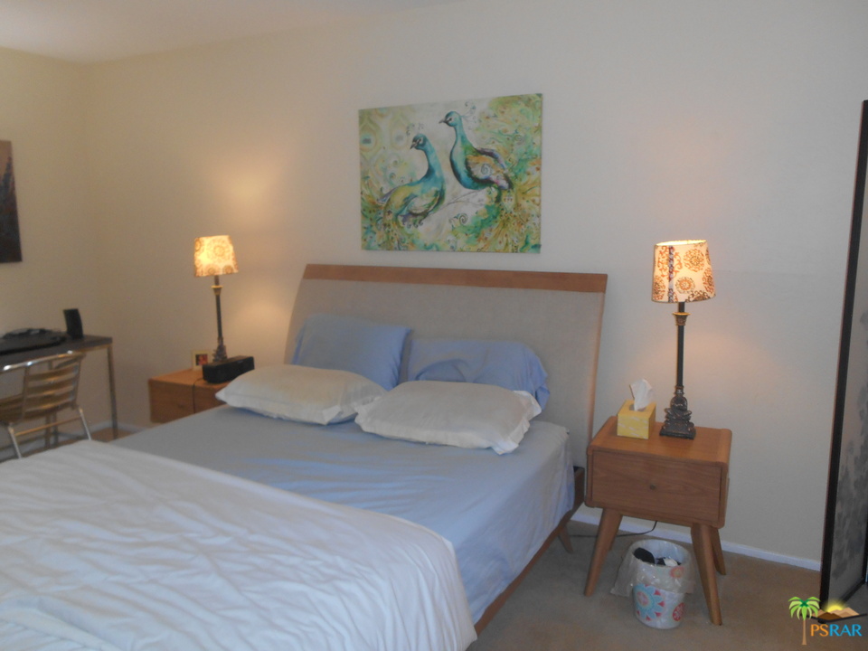 1050 Ramon Road, Unit 20 Palm Springs, CA 92264 - Photo 16 of 35 a bedroom with a bed and a chair