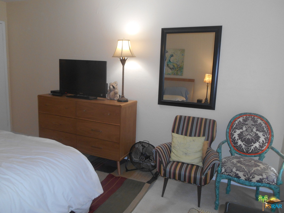 1050 Ramon Road, Unit 20 Palm Springs, CA 92264 - Photo 18 of 35 a bedroom with a bed and chair