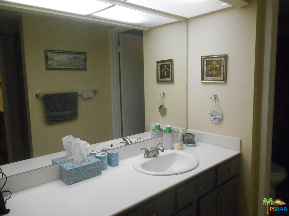 1050 Ramon Road, Unit 20 Palm Springs, CA 92264 - Photo 20 of 35 a bathroom with a double vanity sink and a mirror