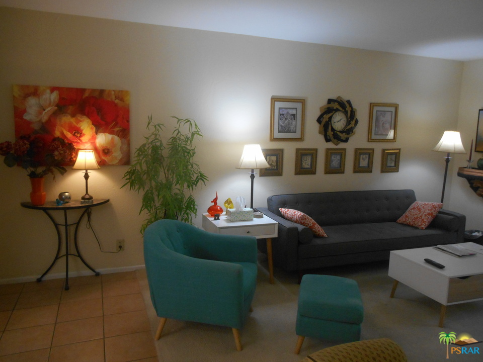 1050 Ramon Road, Unit 20 Palm Springs, CA 92264 - Photo 2 of 35 a living room with furniture and a lamp