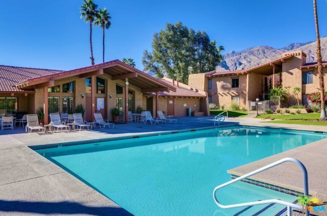 1050 Ramon Road, Unit 20 Palm Springs, CA 92264 - Photo 26 of 35 a view of a patio with swimming pool table and chairs
