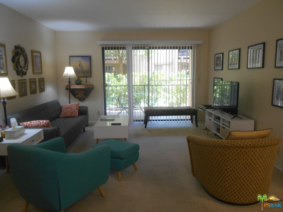 1050 Ramon Road, Unit 20 Palm Springs, CA 92264 - Photo 3 of 35 a living room with furniture and a flat screen tv