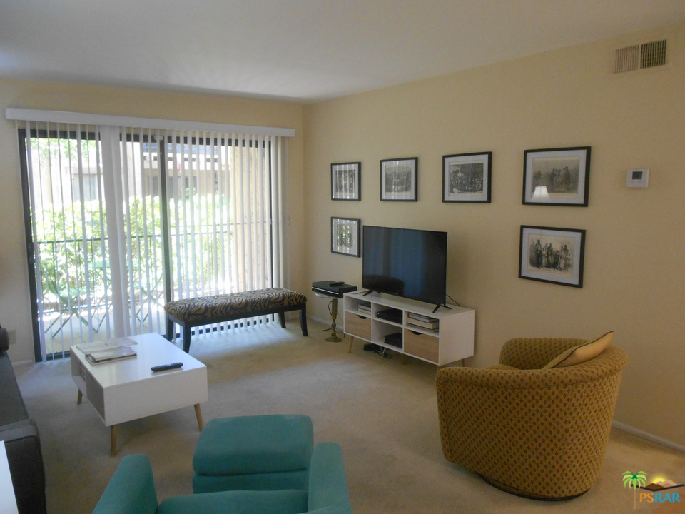 1050 Ramon Road, Unit 20 Palm Springs, CA 92264 - Photo 4 of 35 a living room with furniture and a flat screen tv