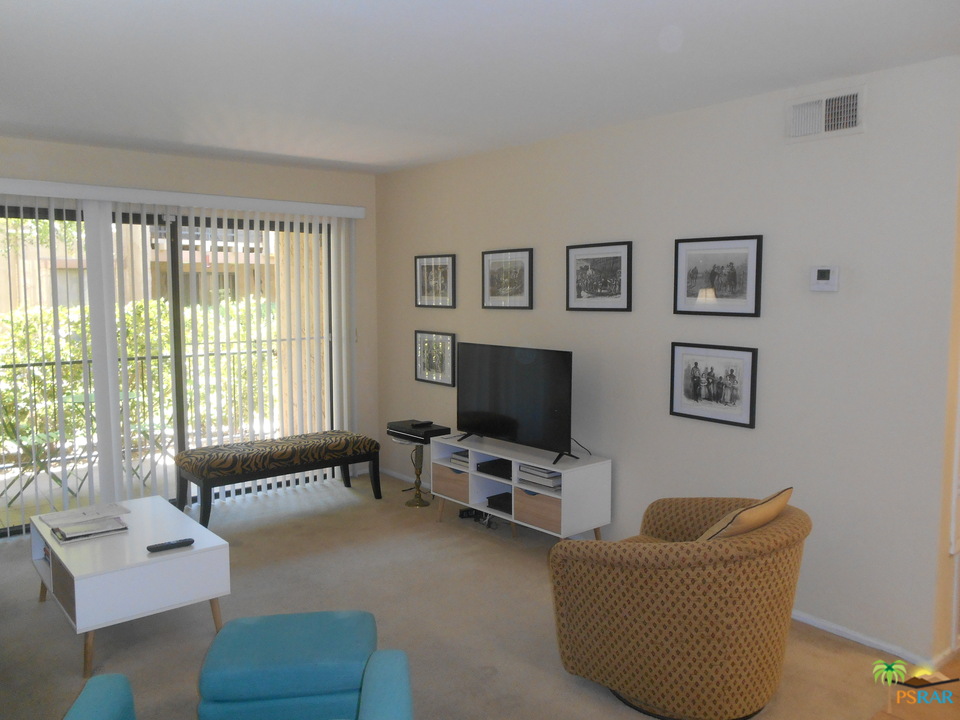 1050 Ramon Road, Unit 20 Palm Springs, CA 92264 - Photo 5 of 35 a living room with furniture and a flat screen tv