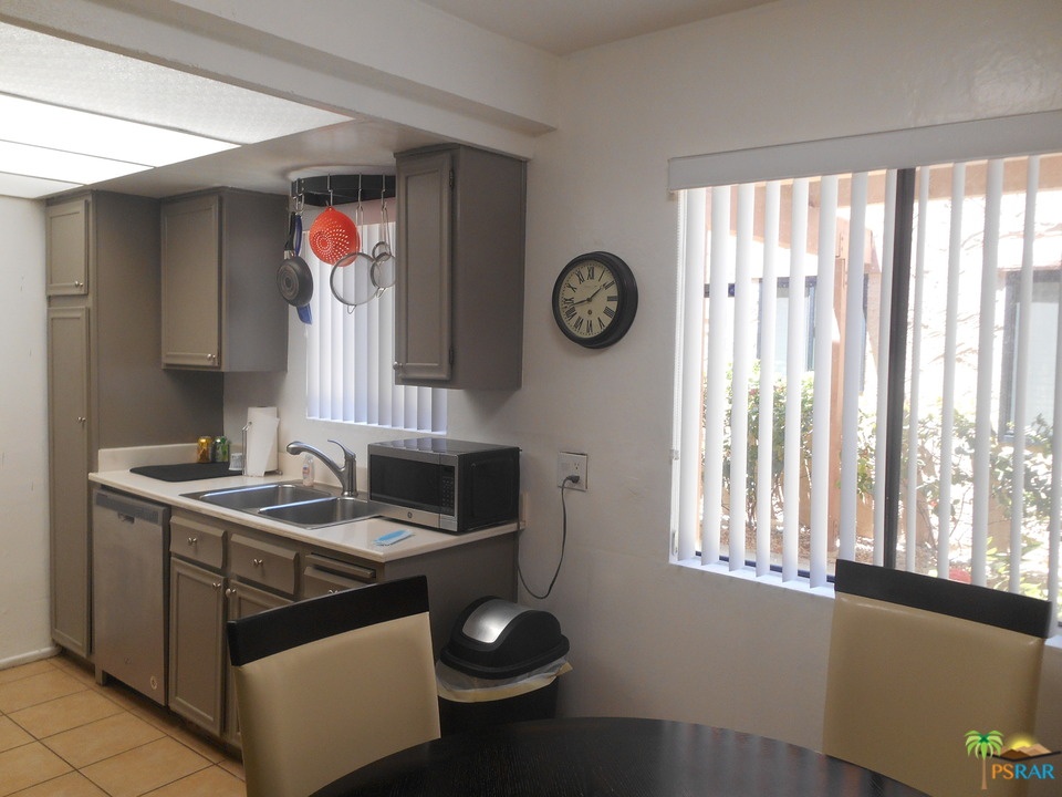1050 Ramon Road, Unit 20 Palm Springs, CA 92264 - Photo 10 of 35 a kitchen with a stove and a white refrigerator