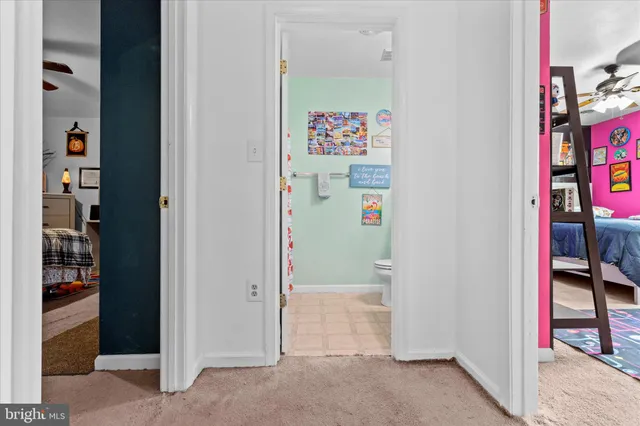 a bathroom with a sink mirror vanity and toilet