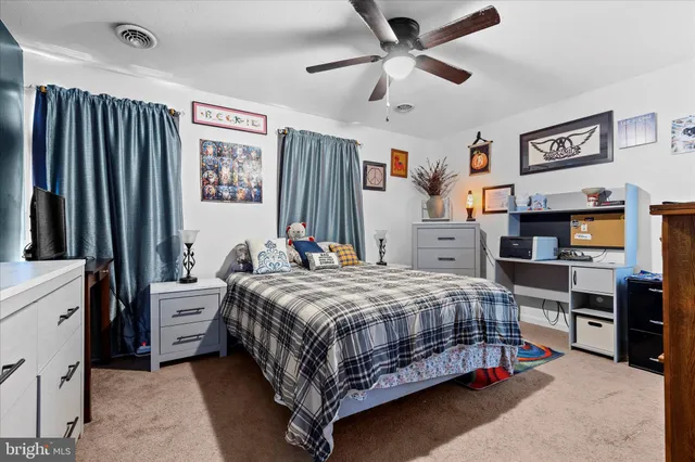 a bedroom with a bed and a television