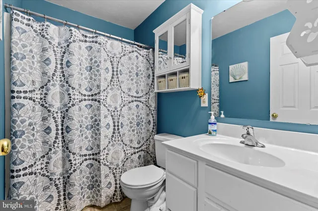 a balcony with wooden floor table and chairs