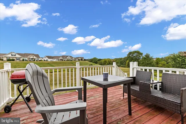a balcony with wooden floor and furniture