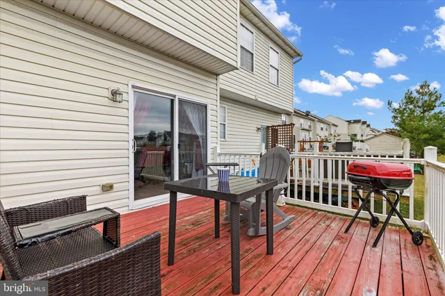 a view of a house with a backyard and deck