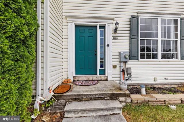 a view of a chair and table in front of house