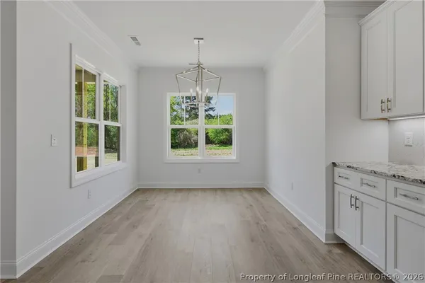 a kitchen with a refrigerator sink and cabinets