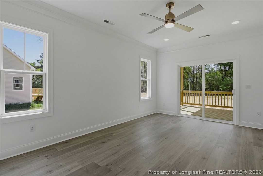 3223 Leaflet Church Road Broadway, NC 27505 - Photo 14 of 30 a view of an empty room with a window and wooden floor