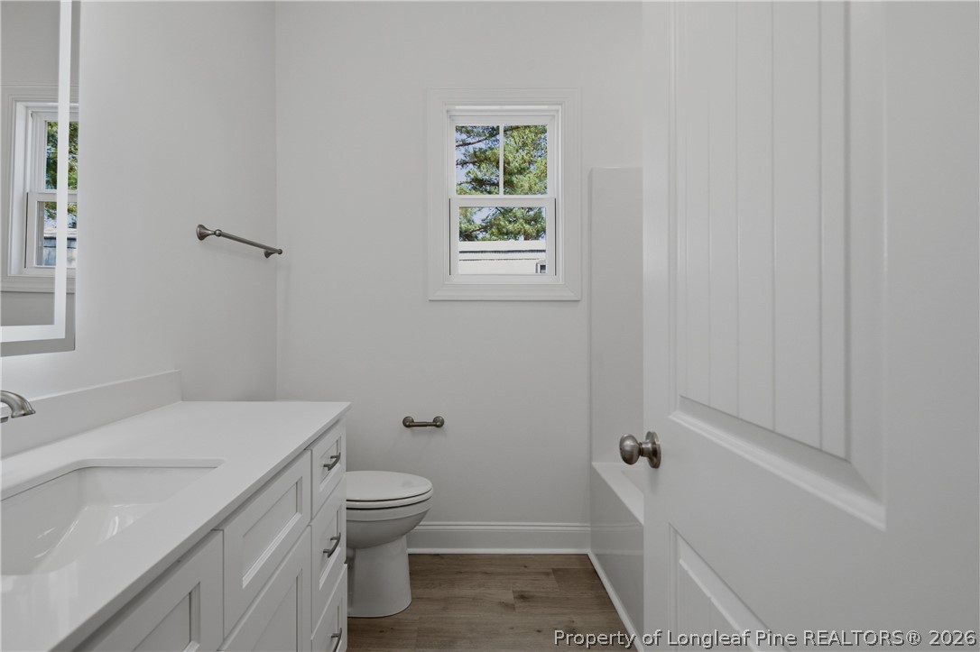 3223 Leaflet Church Road Broadway, NC 27505 - Photo 20 of 30 a bathroom with a sink a toilet and shower