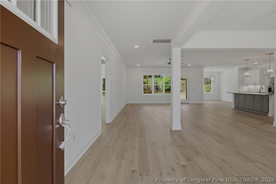 3223 Leaflet Church Road Broadway, NC 27505 - Photo 2 of 30 a view of a big room with wooden floor and windows