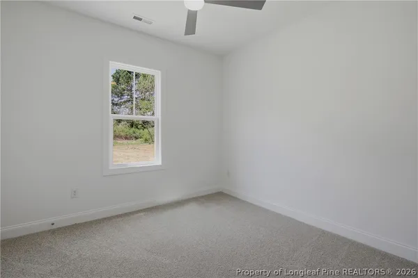 an empty room with a empty space and windows