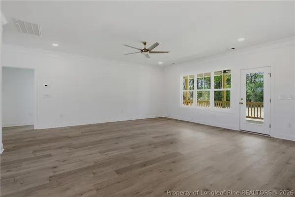 wooden floor in an empty room with a window