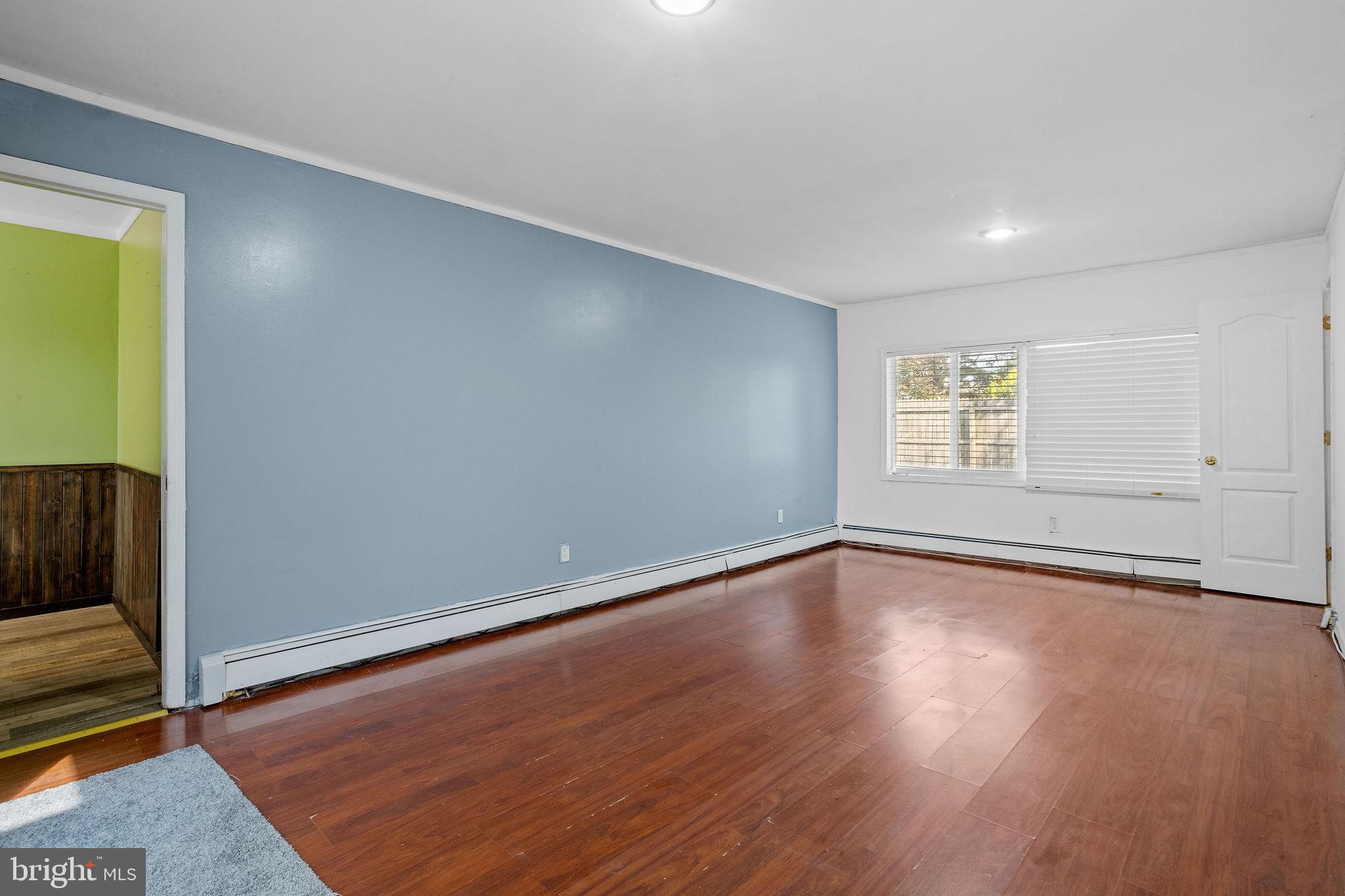 47 Farmbrook Drive Levittown, PA 19055 - Photo 16 of 28 a view of an empty room with wooden floor and a window