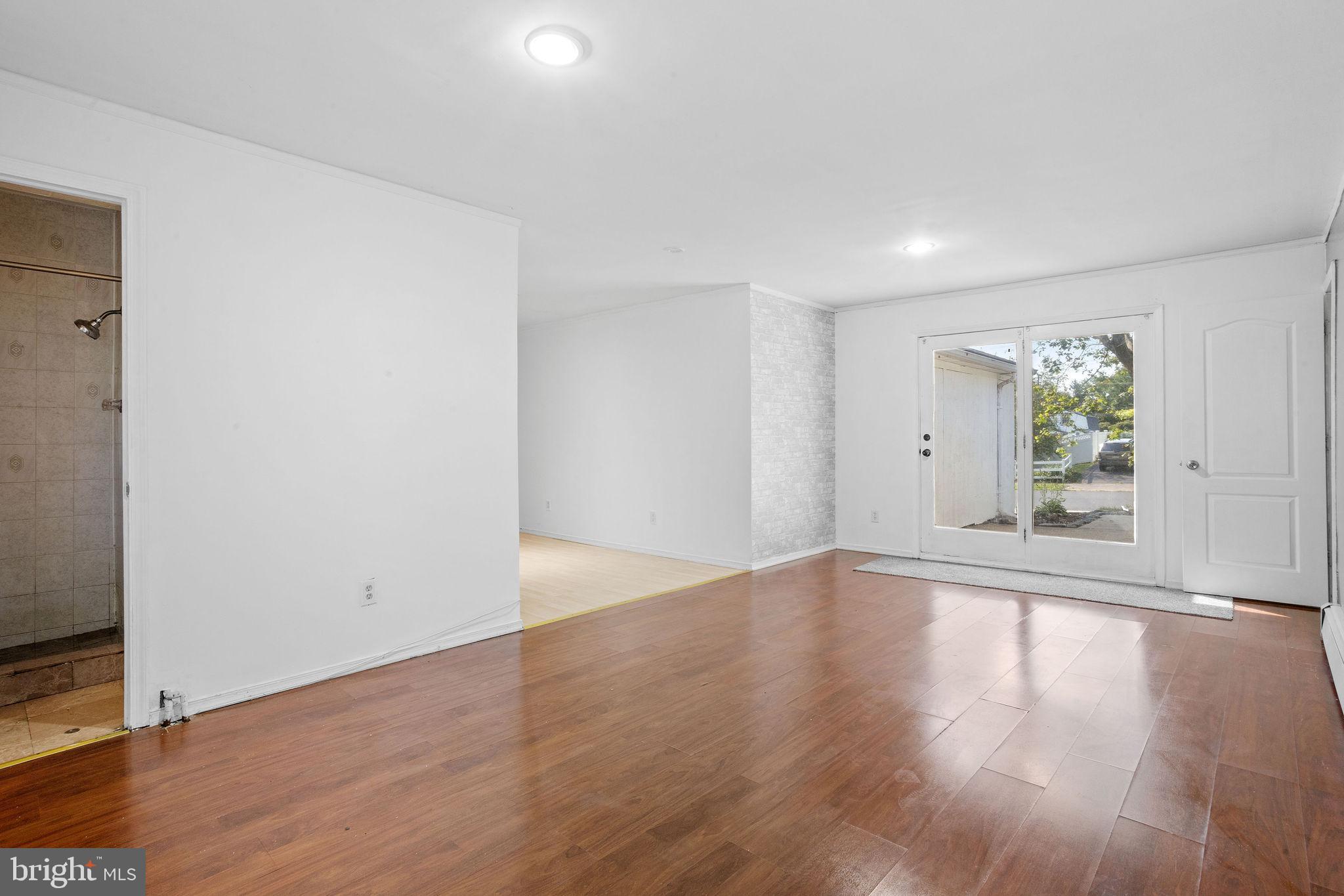 47 Farmbrook Drive Levittown, PA 19055 - Photo 18 of 28 a view of an empty room with wooden floor and a window