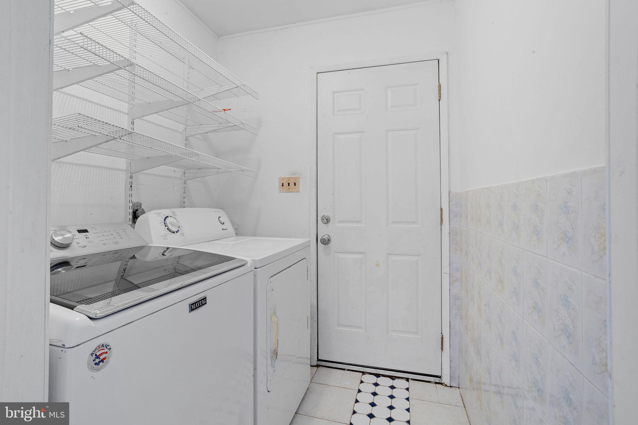 47 Farmbrook Drive Levittown, PA 19055 - Photo 22 of 28 a utility room with cabinets washer and dryer