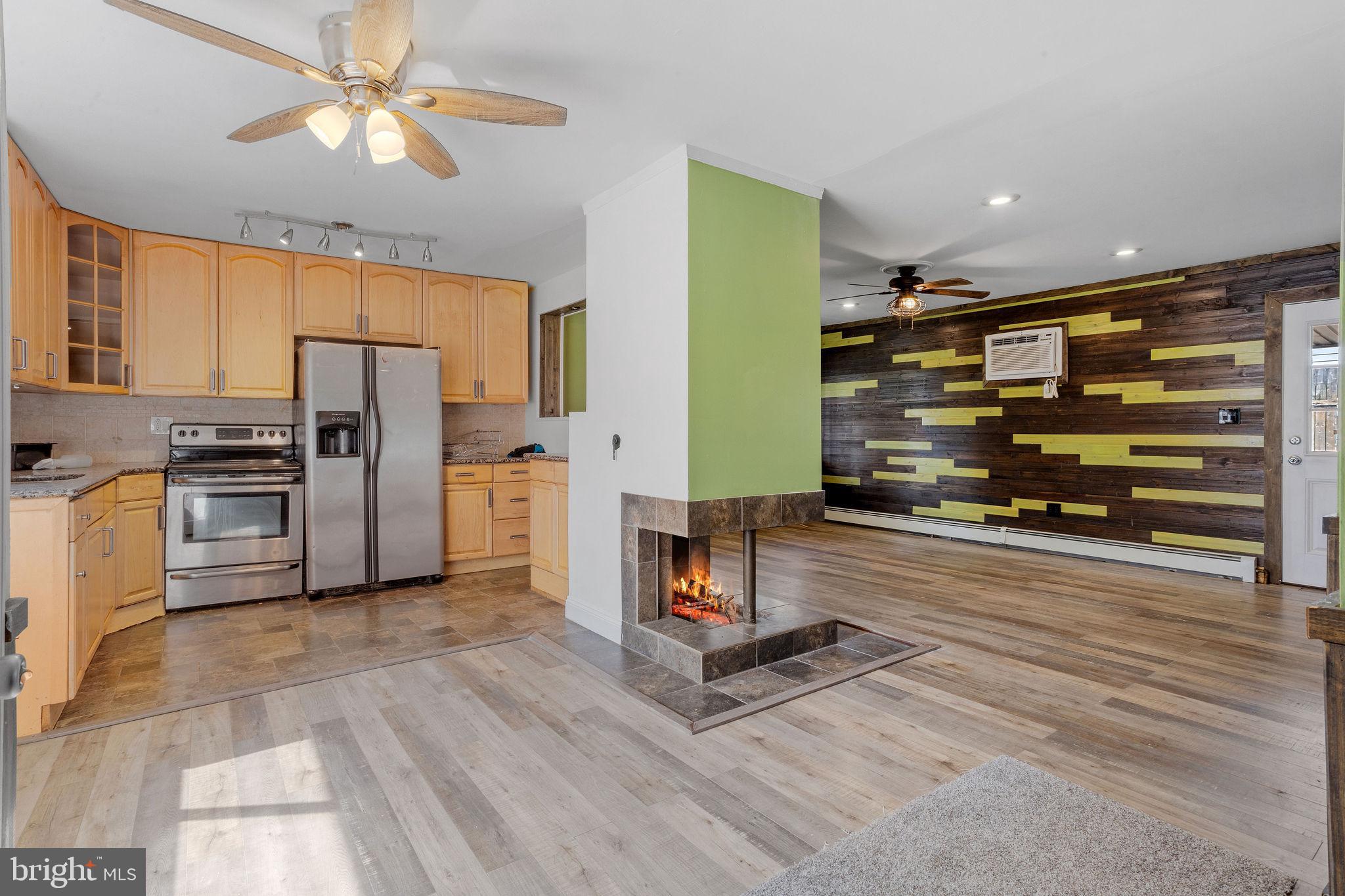 47 Farmbrook Drive Levittown, PA 19055 - Photo 3 of 28 a view of a kitchen with refrigerator and a ceiling fan