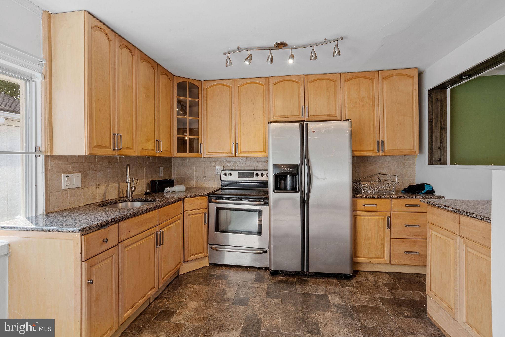 47 Farmbrook Drive Levittown, PA 19055 - Photo 4 of 28 a kitchen with stainless steel appliances granite countertop a refrigerator sink and stove