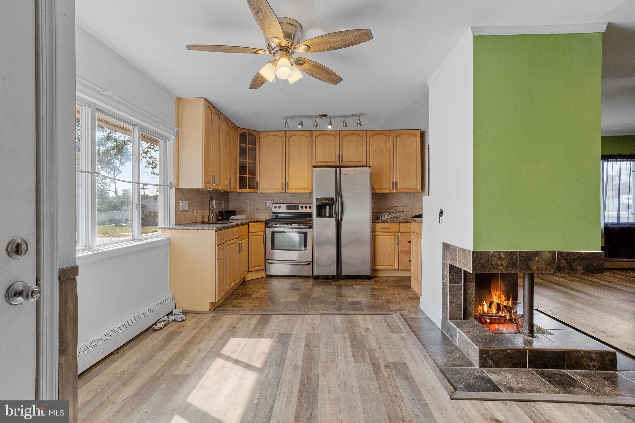 47 Farmbrook Drive Levittown, PA 19055 - Photo 5 of 28 a kitchen with a refrigerator a stove top oven a sink and cabinets