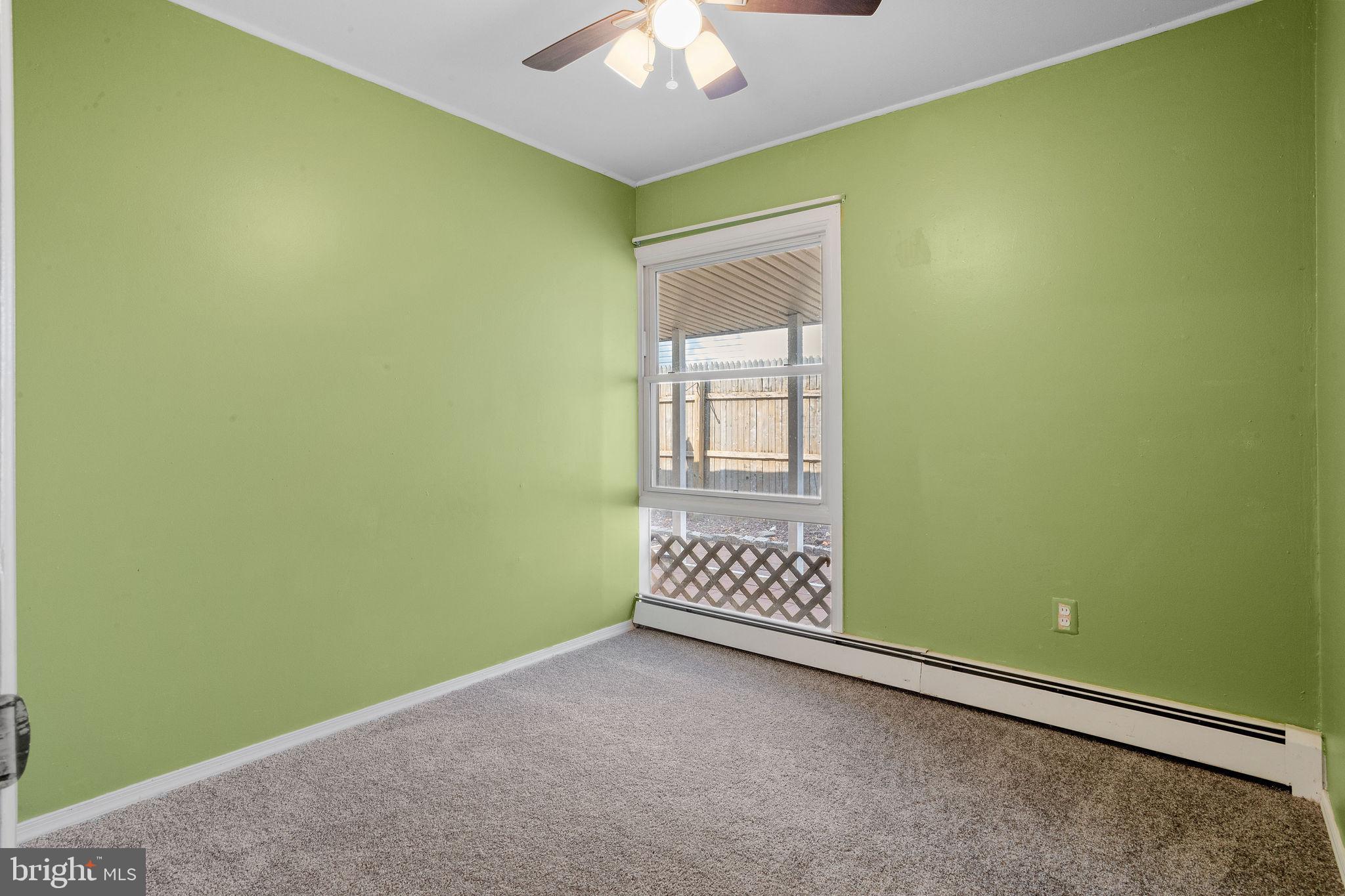 47 Farmbrook Drive Levittown, PA 19055 - Photo 10 of 28 an empty room with a ceiling fan and window