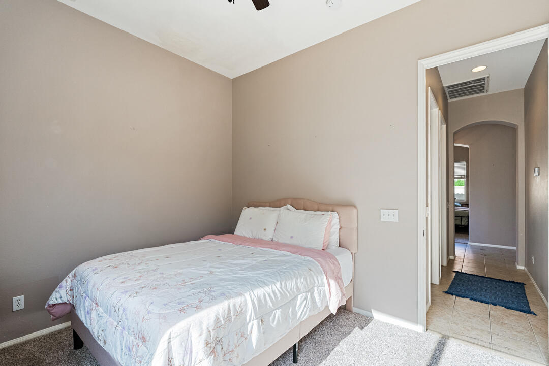 49418 Wayne Street Indio, CA 92201 - Photo 14 of 22 a bedroom with a bed and a mirror