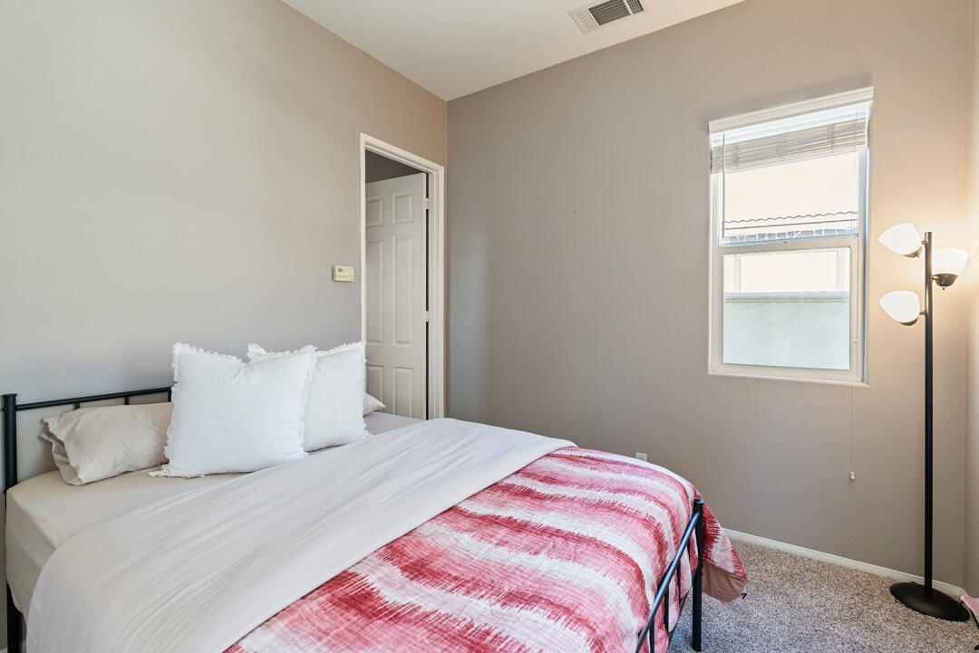 49418 Wayne Street Indio, CA 92201 - Photo 19 of 22 a bedroom with a bed and a window