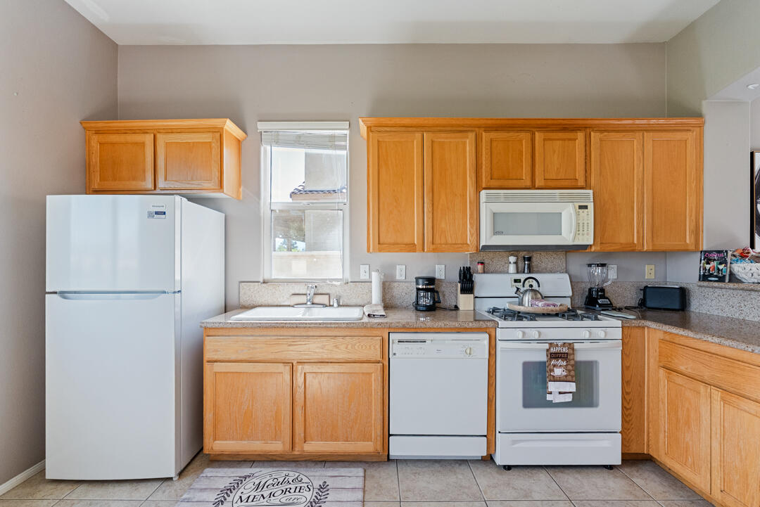49418 Wayne Street Indio, CA 92201 - Photo 5 of 22 a view of a kitchen with a sink cabinets and wooden floor