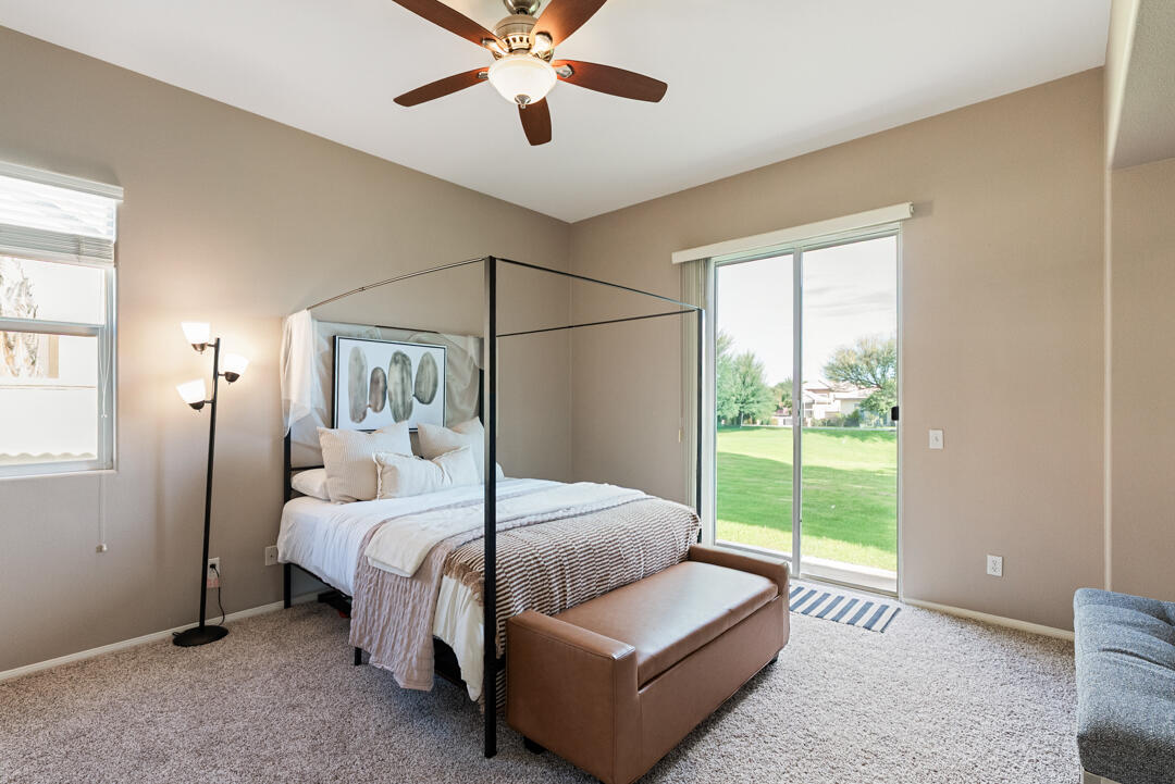 49418 Wayne Street Indio, CA 92201 - Photo 8 of 22 a bedroom with a large bed and a chandelier fan