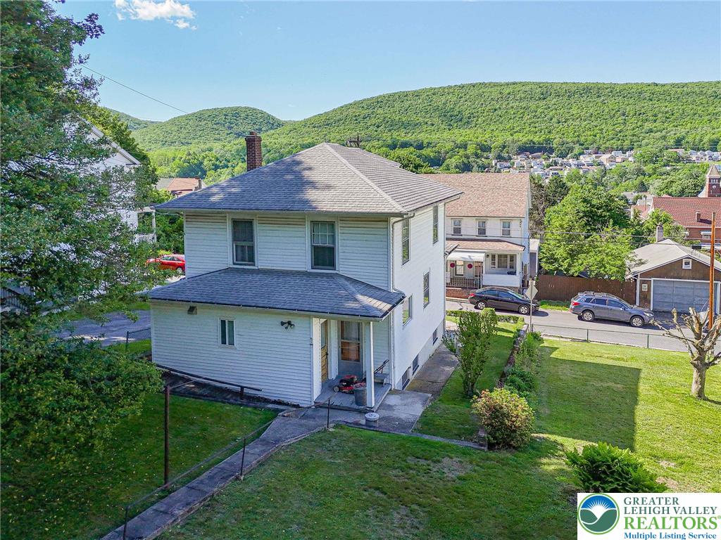 159 West Ridge Street Nesquehoning, PA 18240 - Photo 47 of 55 Discover a charming two-story home, nestled among verdant hills with a detached garage.