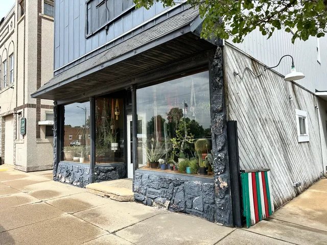 a view of entryway and hall with wooden floor and door