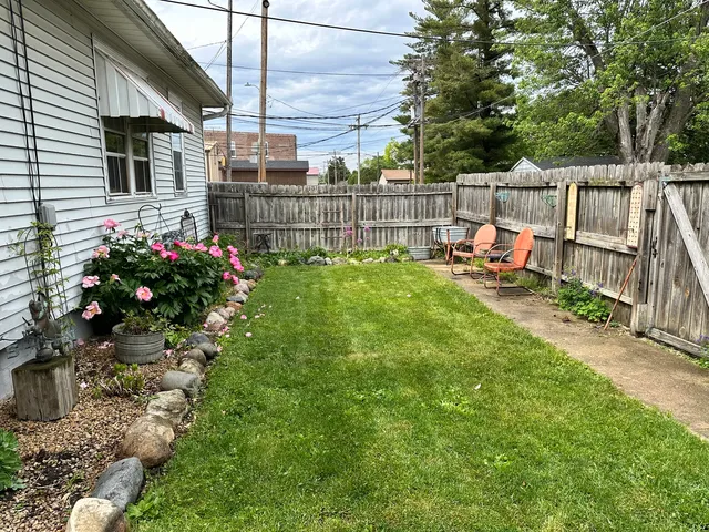 a view of backyard with sitting area