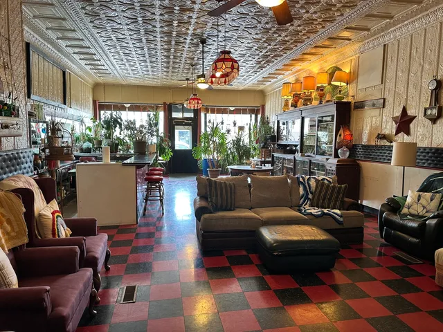 a living room with furniture a rug and a chandelier
